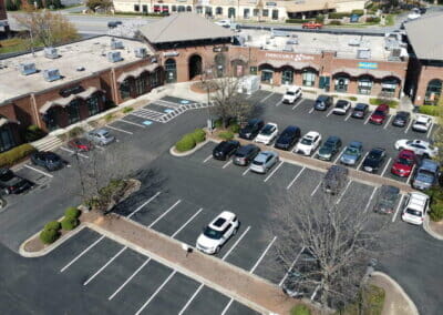 overhead drone view of shopping center parking lot asphalt paving project