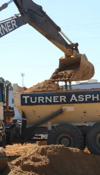 turner asphalt dump truck being filled with excavated material
