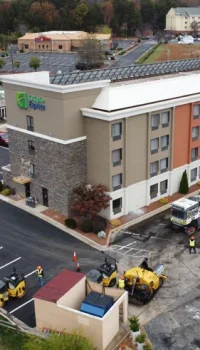 aerial view of a hotel parking lot being paved