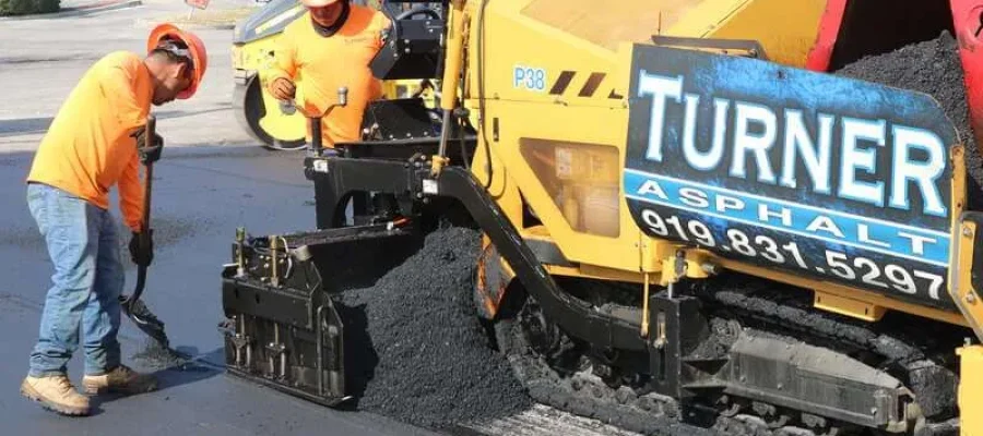 Turner Asphalt crew operating a paving machine during a commercial asphalt installation